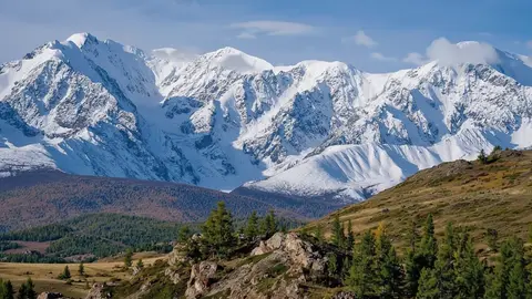 Gemini Omni Flash clip: snow-covered mountain range above larch-covered hills in the Altai