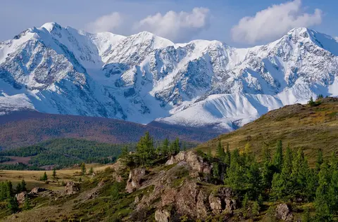 Grok Imagine 1.5 clip: snow-covered mountain range above larch-covered hills in the Altai