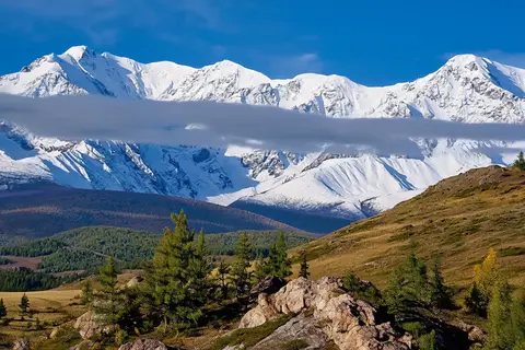 Happy Horse 1.1 clip: snow-covered mountain range above larch-covered hills in the Altai