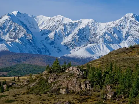 Luma Ray 3.2 clip: snow-covered mountain range above larch-covered hills in the Altai