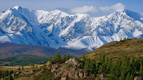 Veo 3.1 Fast clip: snow-covered mountain range above larch-covered hills in the Altai