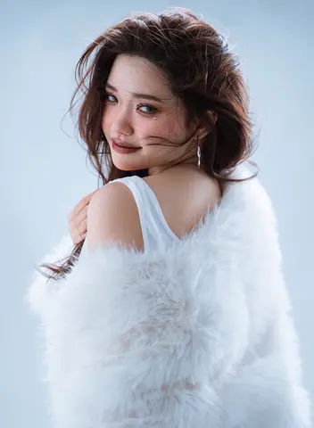 FLUX 3 clip: studio portrait of a woman in a white fur wrap looking back over her shoulder
