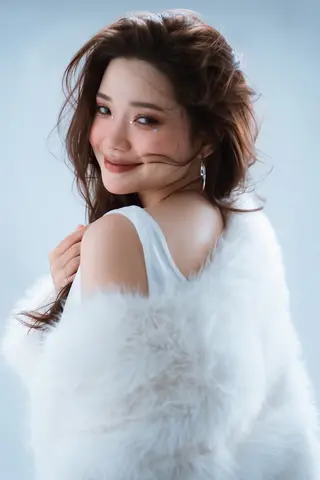 PixVerse V6 clip: studio portrait of a woman in a white fur wrap looking back over her shoulder