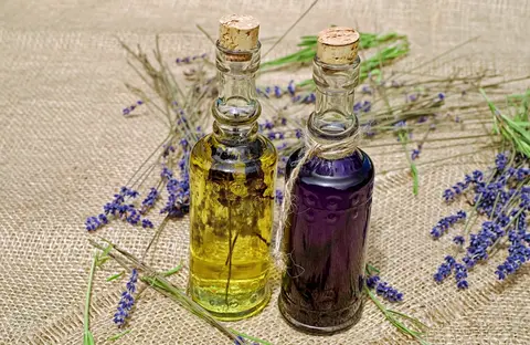 Grok Imagine 1.5 clip: two corked glass bottles of lavender oil on burlap with lavender stems
