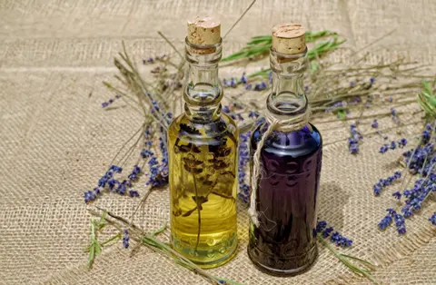 Kling 3.0 clip: two corked glass bottles of lavender oil on burlap with lavender stems