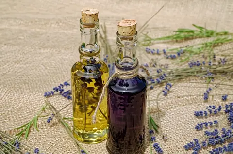 PixVerse V6 clip: two corked glass bottles of lavender oil on burlap with lavender stems