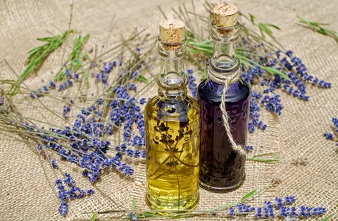 Wan 3.0 clip: two corked glass bottles of lavender oil on burlap with lavender stems